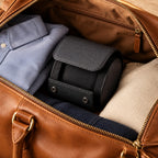 1-slot leather watch roll packed in a leather weekender bag