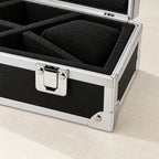 Close-up of the chrome latch, corner and foam compartments of the aluminum watch case