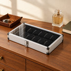 12-slot aluminum display box on a chest of drawers, for scale