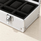 Close-up of the chrome latch, corner and foam compartments of the aluminum watch case