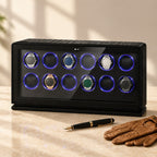 12-watch winder beside a fountain pen and leather gloves