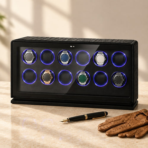 12-watch winder beside a fountain pen and leather gloves