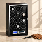 Ebony 12-watch winder cabinet closed, beside a fountain pen and leather gloves