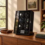 12-watch winder cabinet on a wooden sideboard beside a valet tray and books