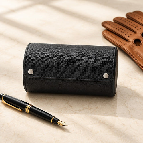 2-slot black watch roll closed, beside a fountain pen and leather gloves
