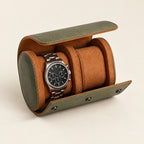 Olive 2-watch barrel travel case open with a watch on one cushion