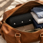 2-watch roll packed in a leather weekender bag, for scale