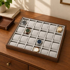 24-slot walnut watch tray on a wooden chest of drawers