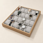24-slot light wooden watch organizer tray with grey pillows and watches