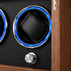 Close-up of a lit holder, chrome knob and walnut frame of the winder cabinet
