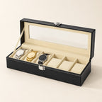 6-slot black faux leather watch box with cream interior and glass lid open