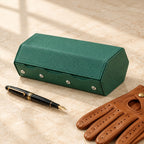 6-slot saffiano hexagon watch case closed, beside a fountain pen and leather gloves