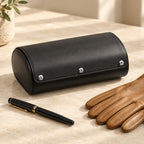 6-slot watch travel case closed, beside a fountain pen and leather gloves