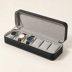 Black 6-slot zippered watch case open, three watches on grey pillows