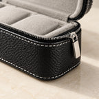 Close-up of the pebbled faux leather, stitching and zip of the 6-slot case