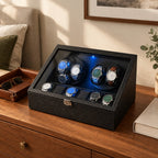 6-watch winder box on a wooden chest of drawers beside a valet tray and a book
