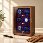 Walnut winder cabinet closed, beside a fountain pen and leather gloves