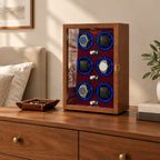 6-watch winder cabinet on a wooden dresser beside a valet tray and books