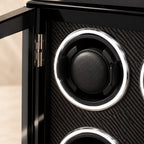 Close-up of a cushioned winding cup on the carbon-pattern panel