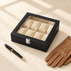 8-slot black croc-texture watch box with a glass lid closed, beside a fountain pen and leather gloves