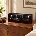 8-watch winder box on a wooden dresser beside a valet tray and books