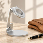 Aluminum charging stand beside a fountain pen and leather gloves