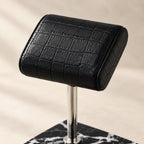 Close-up of the natural black marble watch stand with genuine leather pillow materials and finish