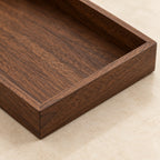 Close-up of the walnut grain and joined corner of the square tray