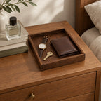 Black walnut valet tray with a watch, key and wallet on a chest of drawers