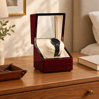 Burgundy single watch winder on a wooden chest of drawers