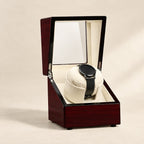 Burgundy lacquer single watch winder, lid open, watch on the pillow