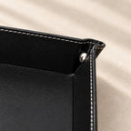 Close-up of the top-stitching and silver snap stud on a corner of the valet tray