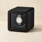 Black carbon-fiber compact single watch winder with a watch behind its window