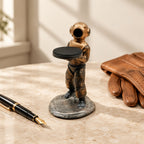 Diver watch stand beside a fountain pen and leather gloves