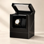 Black gloss double watch winder with the lid open and a watch on one of its two pillows