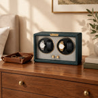 4-watch winder on a wooden dresser beside a valet tray and books