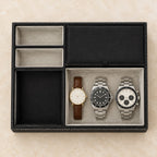 Black faux leather valet tray with 5 compartments, from above, with watches of different sizes