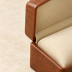 Close-up of the vintage-finish faux leather and cushioned pillow of the flip-top watch box