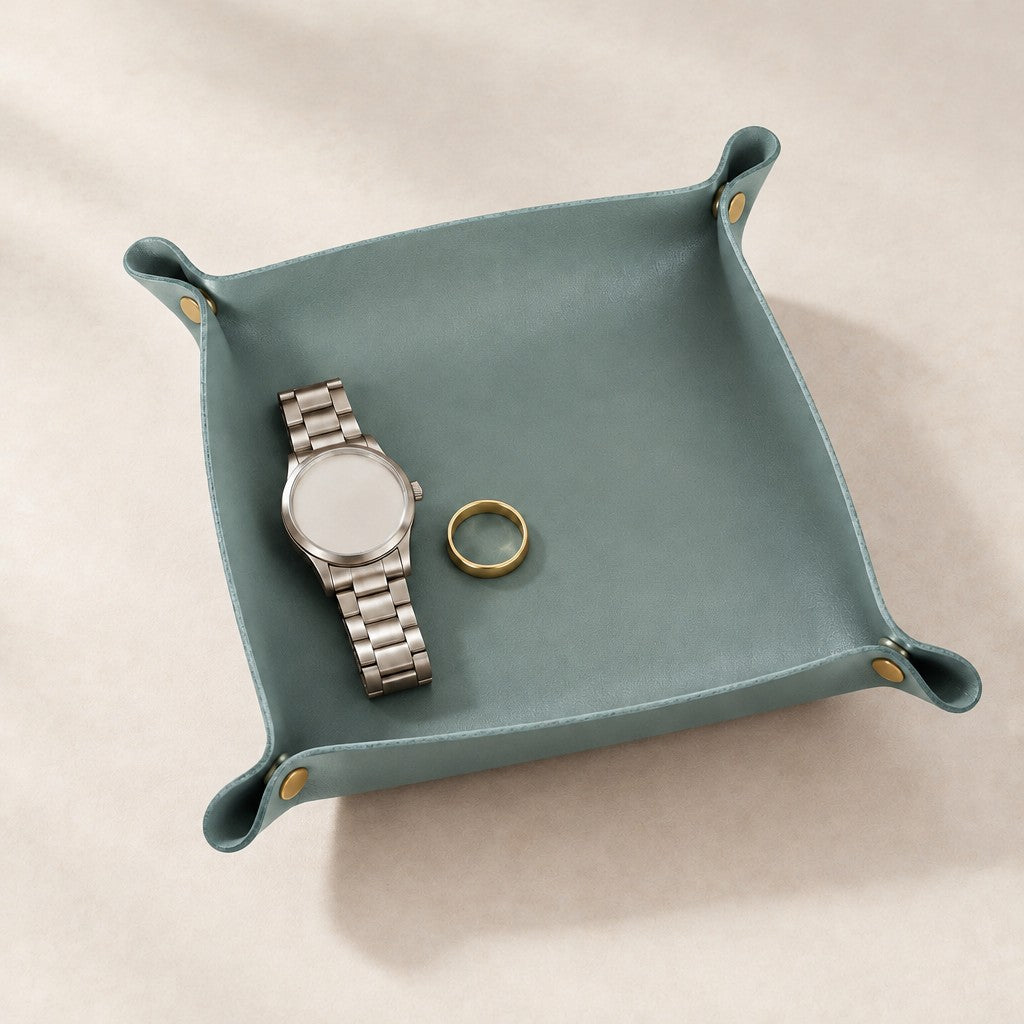 Pale blue foldable leather valet tray with a watch and a ring
