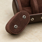 Close-up of a removable suede pillow with its snap buttons