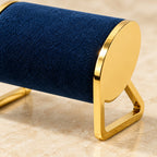 Close-up of the gold-tone metal watch stand materials and finish