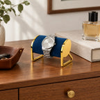 Gold-tone metal watch stand on a chest of drawers, for scale