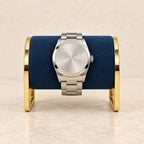 Gold-tone metal watch stand with watches of different sizes
