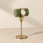 Small gold T-bar stand with a short green velvet bar
