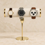 Gold-tone T-bar watch stand with watches of different sizes