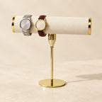 Gold-tone T-bar watch stand with a watch, three-quarter view