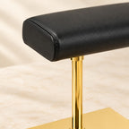 Close-up of the gold-tone double watch stand with leather pillow materials and finish