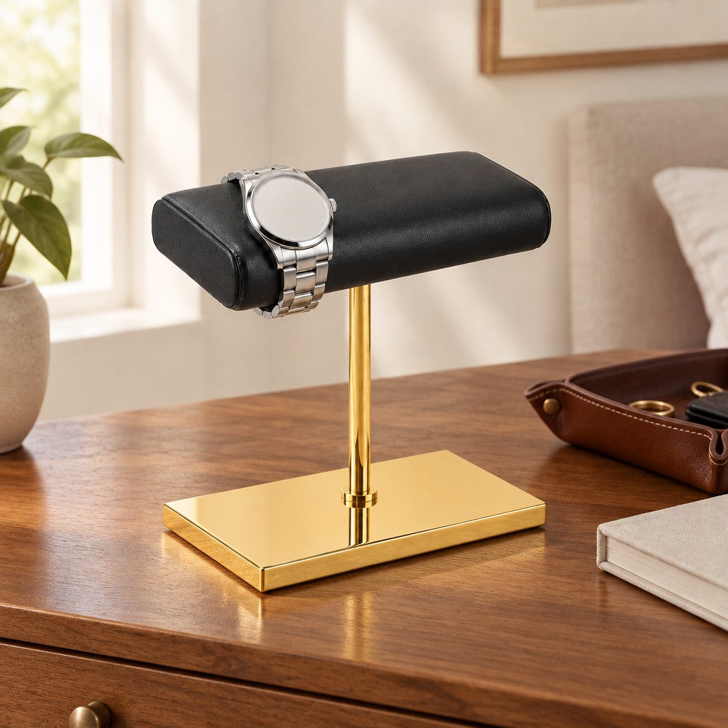 Gold-Tone Double Watch Stand with Leather Pillow on a chest of drawers, for scale