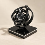 Gyroscope single watch winder with black rings, a watch at the center, on a gloss black base