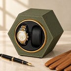 Hexagon watch winder beside a fountain pen and leather gloves